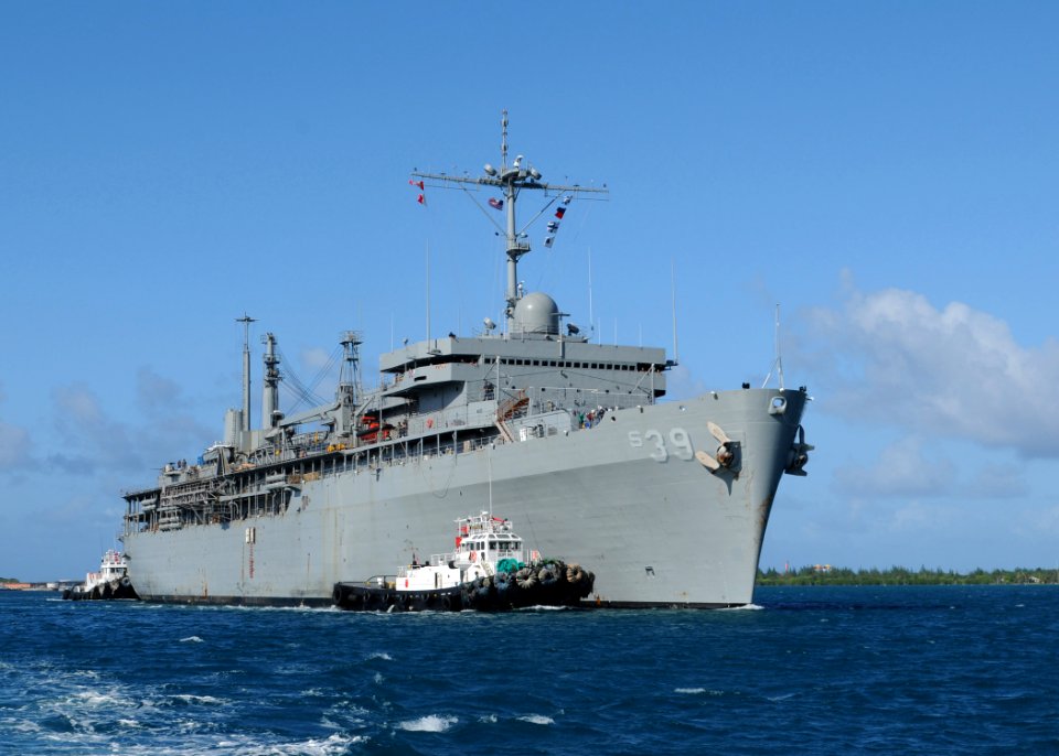 US Navy 111121-N-UE250-166 The submarine tender USS Emory S. Land (AS 39) is escorted through Apra Harbor by a tugboat