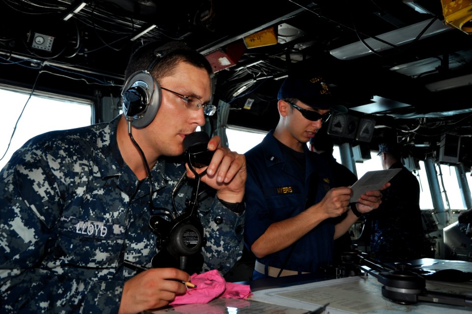 US Navy 111116-N-YX169-309 A Sailor calls in a report over a sound-powered telephone