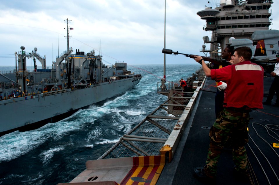 US Navy 111122-N-BT887-046 Gunner's Mate 2nd Class Phillip Grauer, from Sheridan, Ore., fires a phone and distance line to the Military Sealift Com
