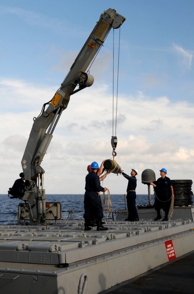 US Navy 111120-N-XQ375-034 Sailors transport an MK-46 torpedo to a magazine aboard guided-missile destroyer USS Mitscher