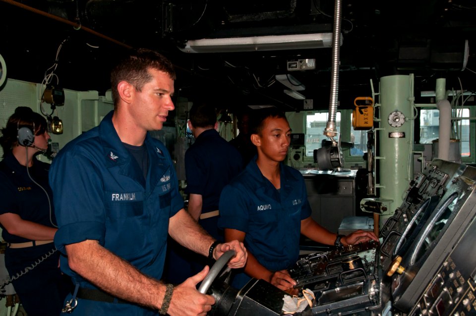 US Navy 111123-N-ER662-530 Boatswain's Mate 3rd Class Taylor Franklin steers the Arleigh Burke-class guided-missile destroyer USS Stethem (DDG 63)