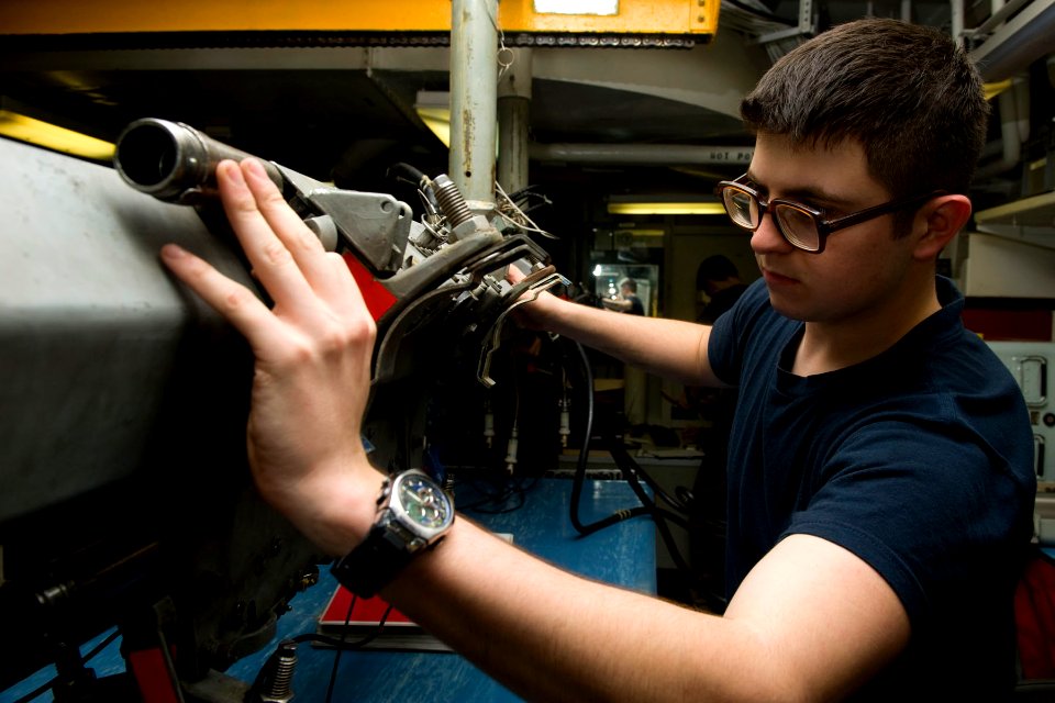 US Navy 111118-N-RJ456-042 Aviation Ordnanceman Airman James Schultz, from Losfresnos, Texas, inspects cabling on an Improved Multiple Ejector Rack