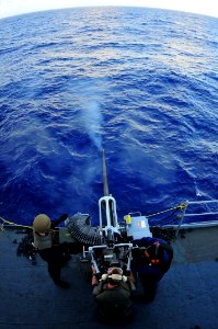 US Navy 111119-N-JH293-025 Capt. Paul Savage, commanding officer of the submarine tender USS Emory S. Land (AS 39), fires a 25mm crew-served machin