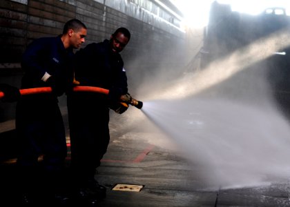 US Navy 111121-N-WJ771-048 Sailors man a fire hose during a crash and salvage drill