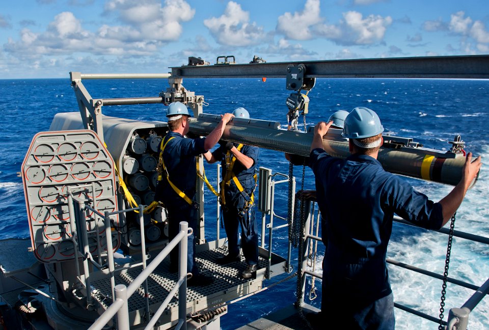 US Navy 111118-N-DX615-010 Fire controlmen load a RIM-116 missiles into the Mk 31 rolling airframe missile (RAM) launcher