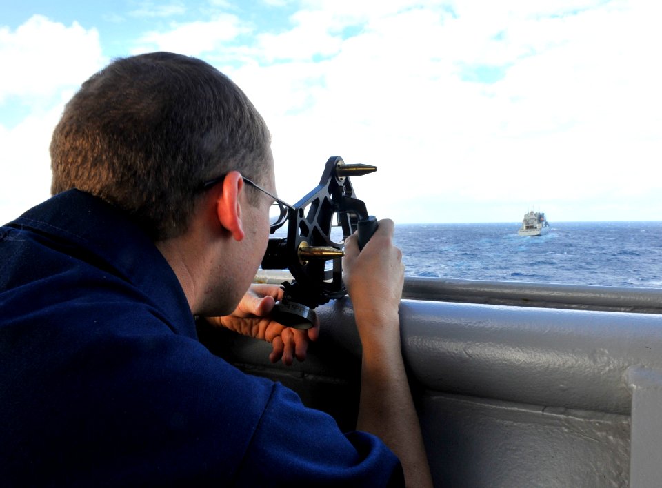 US Navy 111120-N-KS651-222 Lt. j.g. Dustin Holm uses a sextant aboard the amphibious dock landing ship USS Pearl Harbor