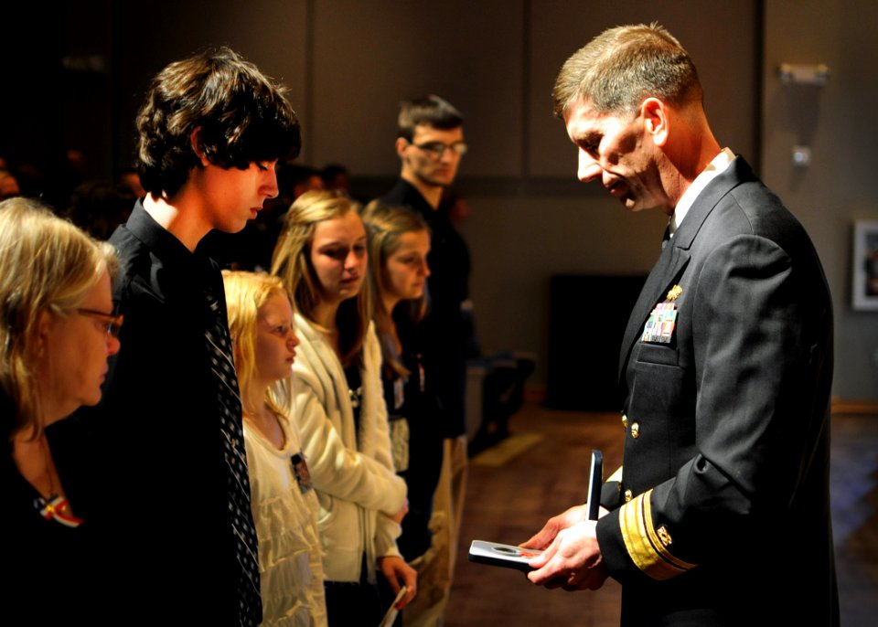 US Navy 111117-N-SN160-174 Rear Adm. Mark Handley, commander of 1st Naval Construction Division, presents a Bronze Star with Valor medal to the 12