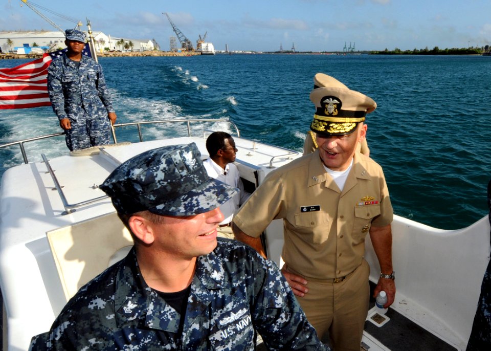 US Navy 111120-N-UE250-068 Rear Adm. Mark Buzby, commander of Military Sealift Command, speaks with Boatswain's Mate 2nd Class Daniel Walker, assig