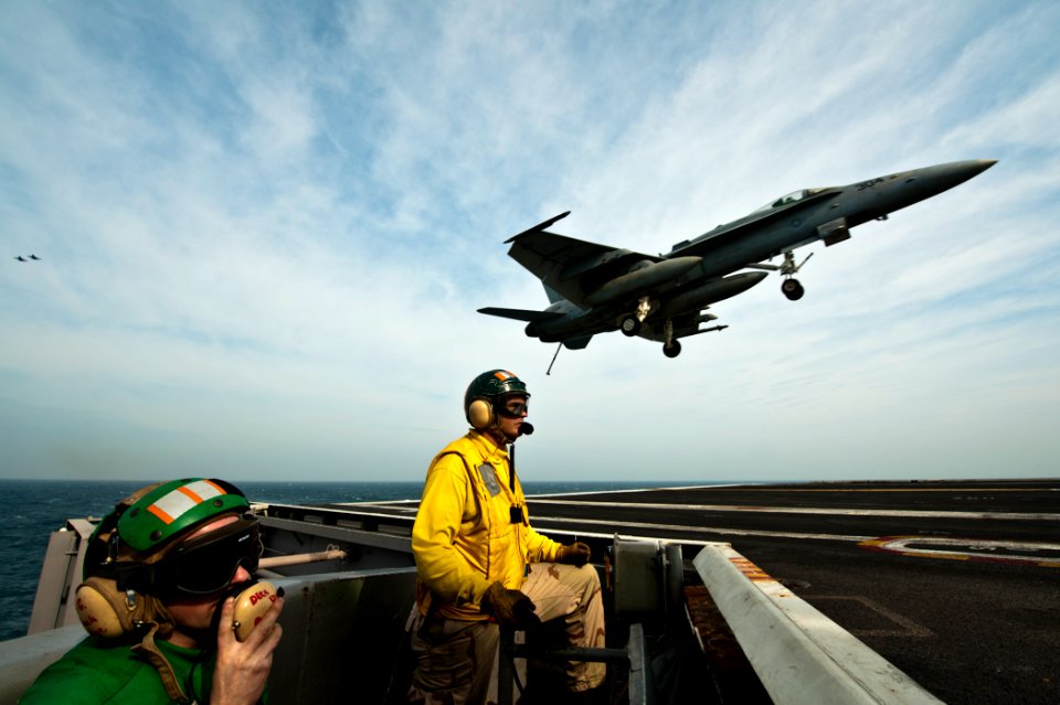 US Navy 111120-N-BT887-182 Aviation Boatswain's Mate (Equipment) 2nd Class Corey Martin and Lt. Stephen Hiers man the arresting gear officer statio