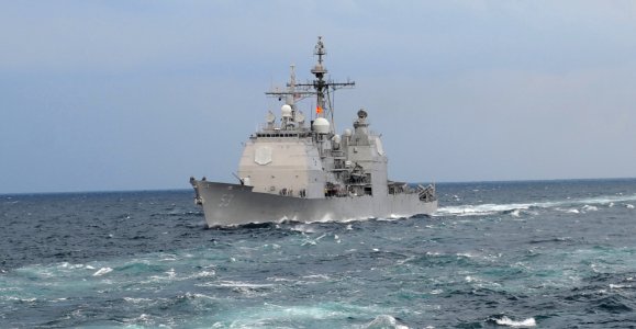 US Navy 111122-N-OY799-140 The Ticonderoga-class guided-missile cruiser USS Mobile Bay (CG 53) transits behind the Nimitz-class aircraft carrier US