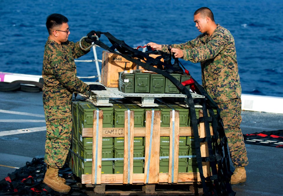 US Navy 111119-N-PB383-017 Marines aboard the amphibious transport dock ship USS New Orleans (LPD 18) secure cargo for a vertical replenishment wit