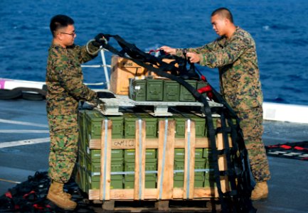 US Navy 111119-N-PB383-017 Marines aboard the amphibious transport dock ship USS New Orleans (LPD 18) secure cargo for a vertical replenishment wit