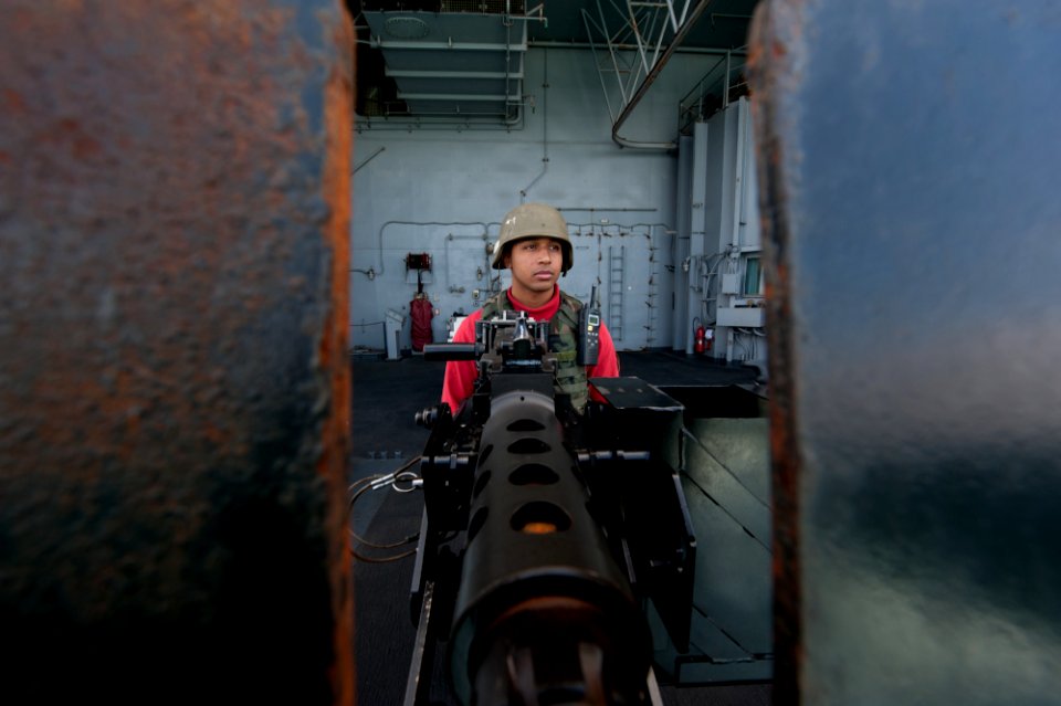US Navy 111123-N-OY799-006 Aviation Ordnanceman Airman Hector Espinosa, from Sinton, Texas, stands .50 caliber machine gun watch on the fantail abo