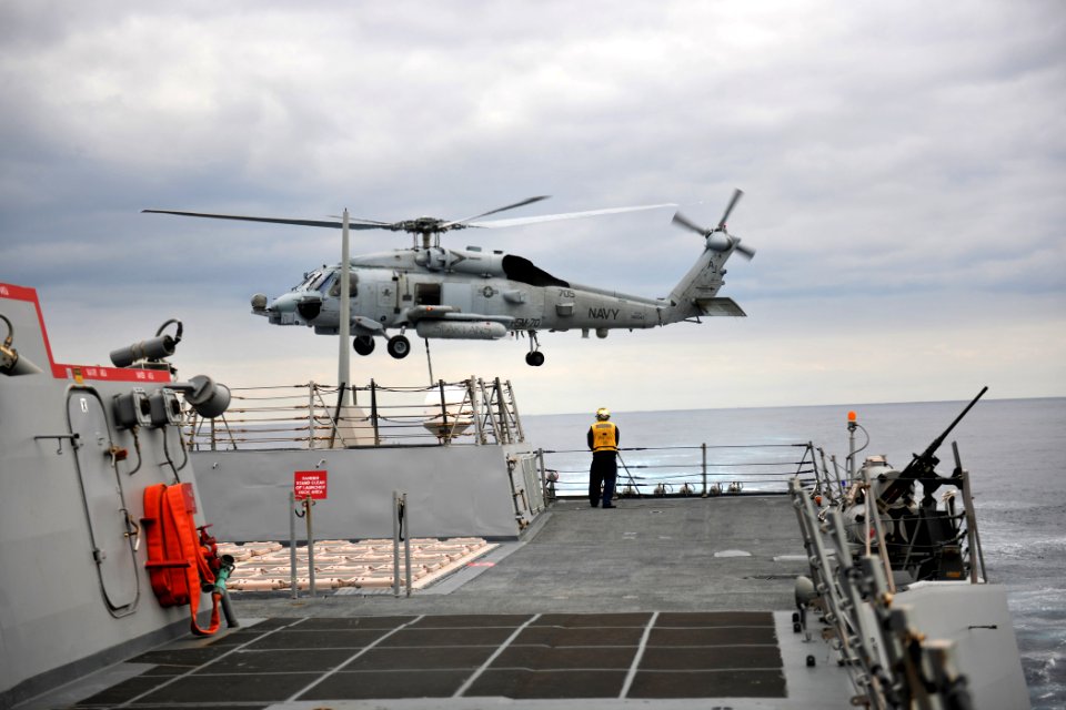 US Navy 111129-N-YZ751-405 A helicopter departs the ship