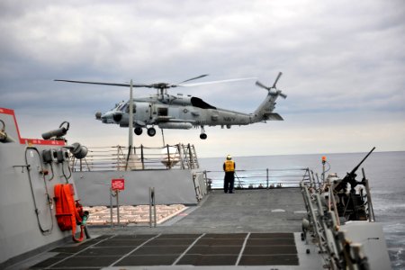 US Navy 111129-N-YZ751-405 A helicopter departs the ship