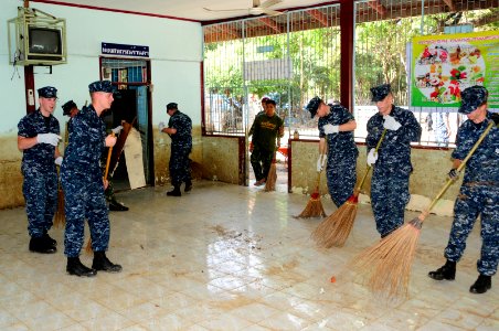 US Navy 111120-N-WV964-053 Sailors from the guided-missile destroyer USS Lassen (DDG 82) sweep mud and debris from a cafeteria during a community s