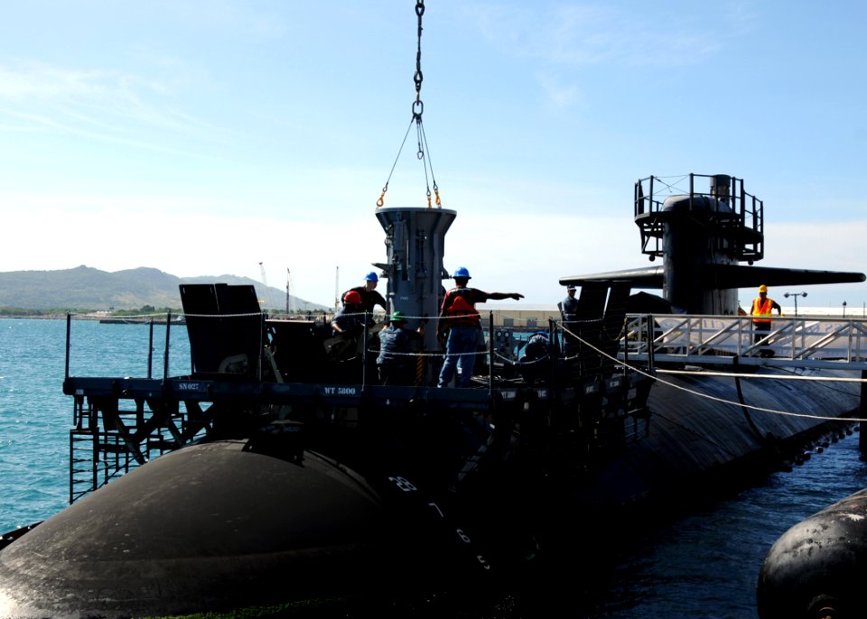 US Navy 111123-N-UE250-040 Sailors assigned to the submarine tender USS Frank Cable (AS 40) lower a missile tube extension loader