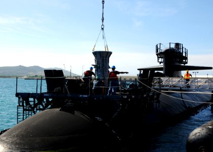 US Navy 111123-N-UE250-040 Sailors assigned to the submarine tender USS Frank Cable (AS 40) lower a missile tube extension loader