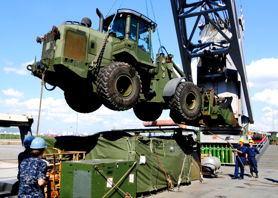 US Navy 111128-N-WJ771-130 Sailors assigned to the forward-deployed amphibious dock landing ship USS Tortuga (LSD 46) offload a tractor, rubber-tir