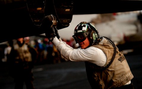 US Navy 111123-N-OY799-224 A Sailor checks the tail hook of an F-A-18F Super Hornet from the Tophatters of Strike Fighter Squadron (VFA) 14