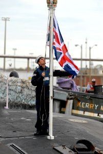 US Navy 111128-N-NK458-092 A sailor assigned to the Royal Navy submarine HMS Astute (S119) prepares to raise the flag as the ship arrives at Naval photo