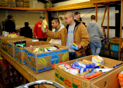 US Navy 111121-N-ZK021-002 Sailors assigned to commands based at Naval Air Station Whidbey Island sort donated items for holiday baskets at North W