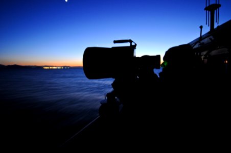 US Navy 111128-N-YM590-034 Seaman Apprentice Scott Kinley looks through a night-vision scope aboard the guided-missile cruiser USS Anzio (CG 68)