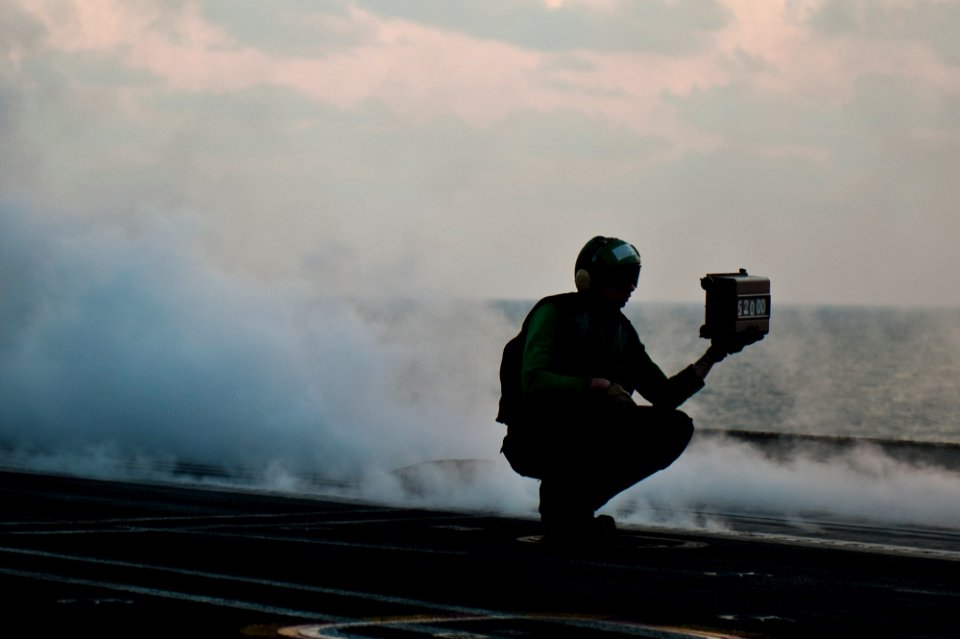 US Navy 111125-N-BT887-329 A Sailor displays aircraft weight before a launch aboard the Nimitz-class aircraft carrier USS John C. Stennis (CVN 74)
