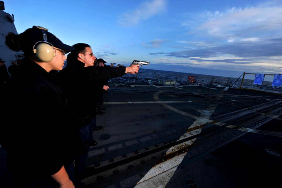 US Navy 111128-N-YZ751-030 Sonar Technician (Surface) Seaman Apprentice Vincent J. Boudreau fires a 9mm pistol during a small arms qualification co