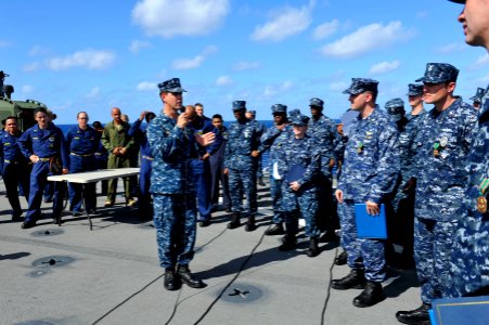 US Navy 111124-N-KS651-120 Cmdr. Homer Denius, commanding officer of the Dock landing ship USS Pearl Harbor (LSD 52), visits with the crew after fr