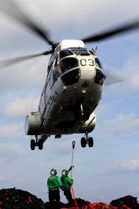 US Navy 111122-N-XE109-396 Logistics Specialist 3rd Class Christian T. Dawson, right, and Logistics Specialist 1st Class Mitch A. Gosha attach carg