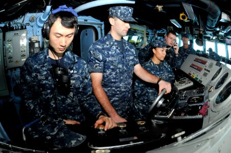 US Navy 111126-N-KM175-007 Sailors man the conning station of the forward-deployed amphibious assault ship USS Essex (LHD 2) during an underway rep