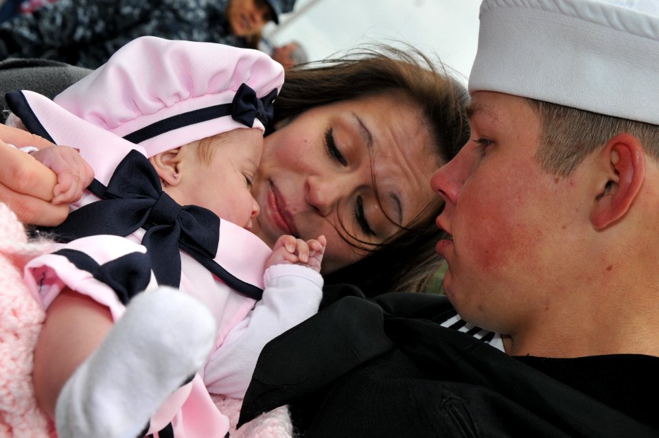 US Navy 111208-N-DG679-170 A Sailor meets his four-month-old daughter for the first time during the homecoming