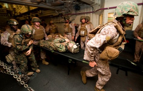 US Navy 111209-N-PB383-225 Hospital corpsmen assigned to the 11th Marine Expeditionary Unit (11th MEU) transport simulated casualties in the well d