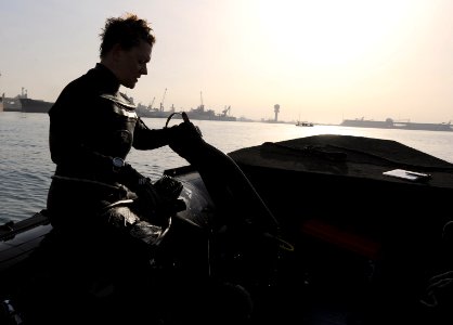 US Navy 111210-N-BA263-249 Chief Master-at-Arms Cris Miller, assigned to Commander, Task Group 56.1, removes her fins after conducting anti-terrori
