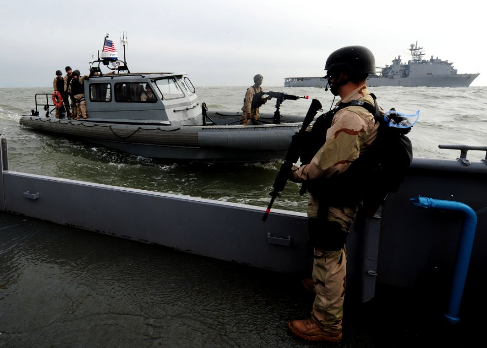 US Navy 111213-N-NR955-173 Operations Specialist Matthew A. Hypes stands guard aboard the Navy auxiliary ship USS Hugo (NS-8201)