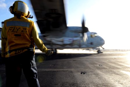 US Navy 111207-N-XE109-076 Aviation Boatswain's Mate (Handling) 3rd Class Clarissa K. Quick signals to a C-2 Greyhound as it launches from the flig