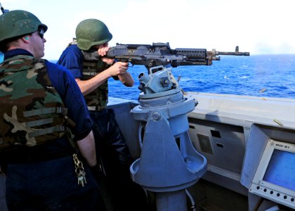 US Navy 111212-N-ZF681-770 Ensign Timothy Eick fires a M-240 machine gun aboard the guided-missile destroyer USS Halsey (DDG 97). Halsey is on a sc