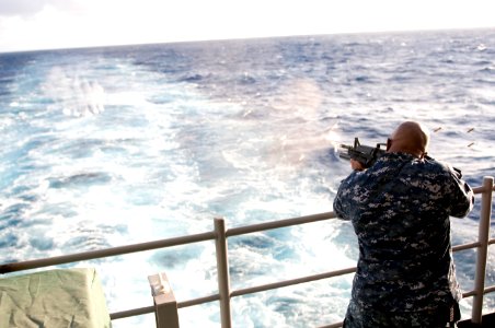 US Navy 111208-N-GZ832-355 A Sailor participates in a familiarization fire exercise on the fantail