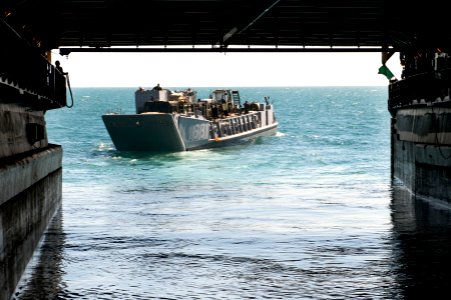 US Navy 111211-N-KS651-326 A landing craft utility departs the well deck of the amphibious dock landing ship USS Pearl Harbor (LSD 52)