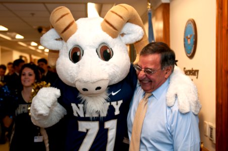 US Navy 111209-N-PM781-010 Secretary of Defense (SECDEF) Leon Panetta is greeted by Bill the Goat, the U.S. Naval Academy mascot, during a pep-rall photo