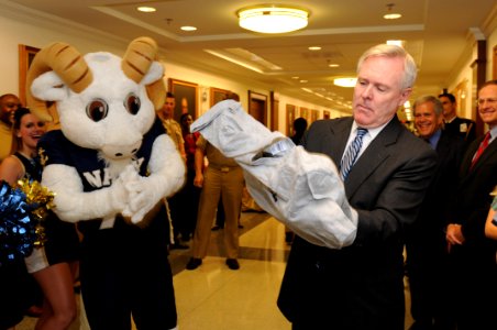 US Navy 111209-N-PM781-075 Secretary of the Navy (SECNAV) the Honorable Ray Mabus tries on a shirt, a gift from Bill the Goat, the U.S. Naval Acade