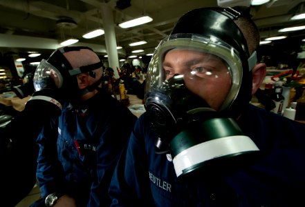 US Navy 111212-N-DR144-251 Machinist's Mate 2nd Class Joshua Beutler listens to training while wearing his MCU-2P protective mask