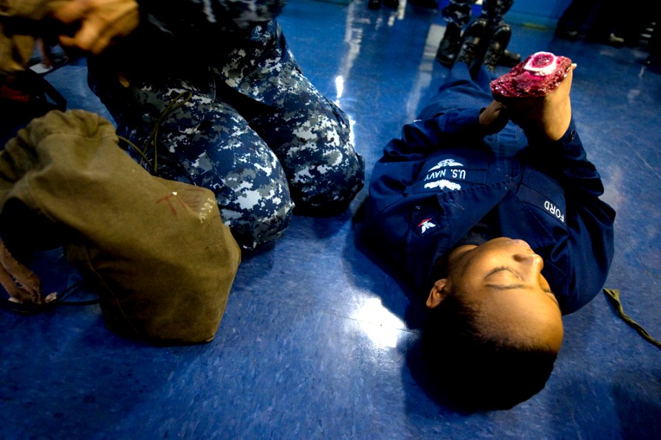 US Navy 111212-N-NL401-015 Medical personnel are filmed performing GITMO 8 training for a later broadcast to Sailors aboard the aircraft carrier US