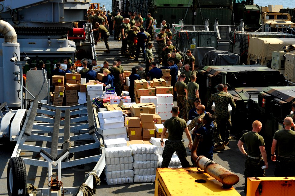 US Navy 111210-N-KS651-381 Sailors and Marines aboard USS Pearl Harbor move supplies during a replenishment at sea