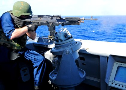 US Navy 111212-N-ZF681-897 Gunner's Mate 2nd Class Erik Trudel fires a M-240 machine gun aboard the guided-missile destroyer USS Halsey (DDG 97)