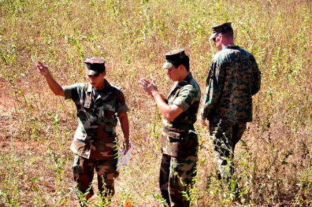 US Navy 111212-A-TF780-065 Sgt. Mark Miller bserves Salvadoran Marines use a compass to help them complete a land navigation course on Plaza De Arm photo