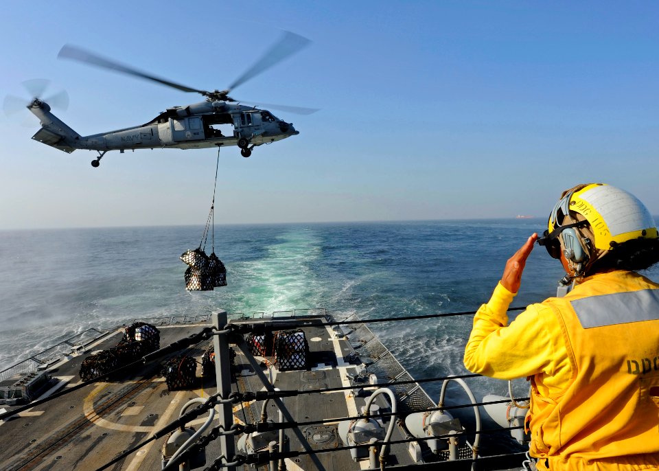 US Navy 111213-N-VH839-020 A Sailor signals a helicopter