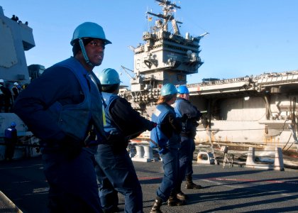 US Navy 111214-N-FI736-249 Sailors aboard the Arleigh Burke-class guided-missile destroyer USS James E. Williams (DDG 95) handle the phone and dist