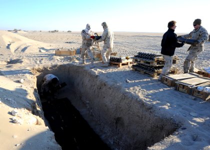 US Navy 111214-N-BA263-205 Explosive ordnance disposal technicians assigned to Commander, Task Group (CTG) 56.1 build a 1,500-pound munitions dispo